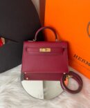 Bolsa Hermes Kelly Mini 20 - Vinho/Dourado